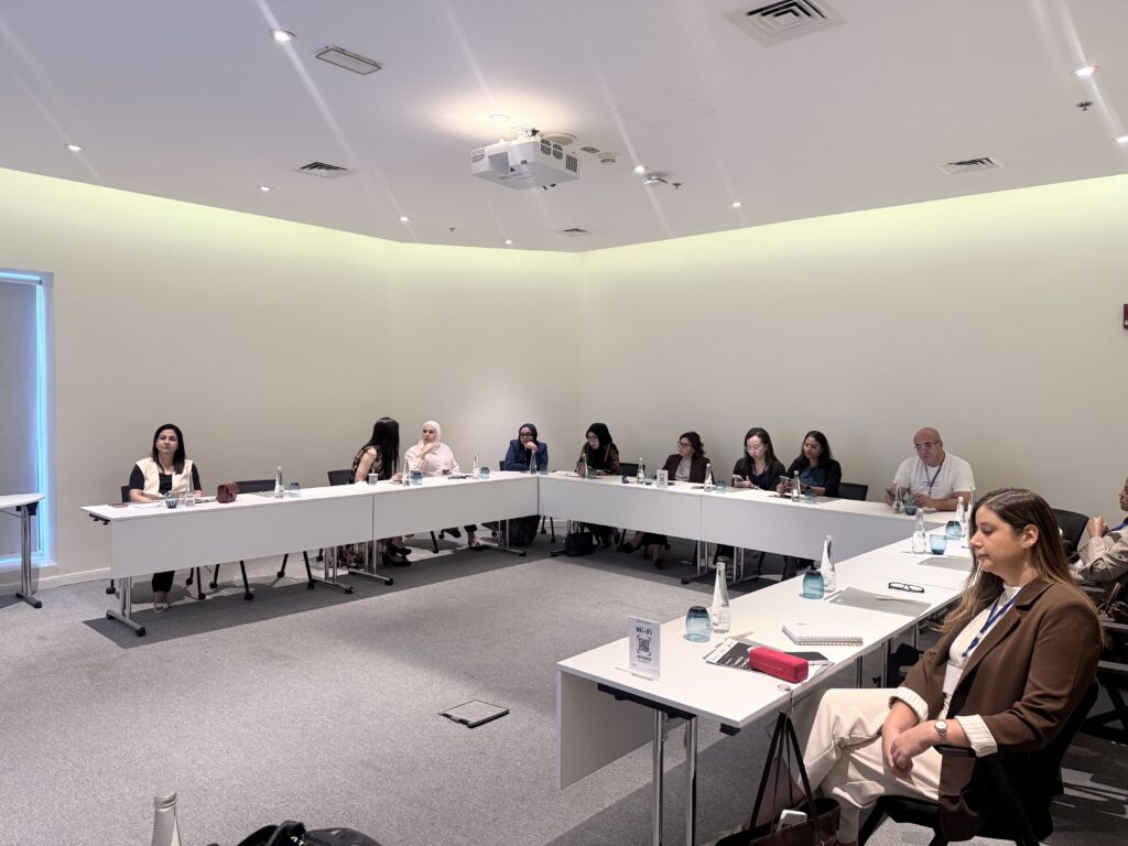 A second view of participants seated around the course tables.