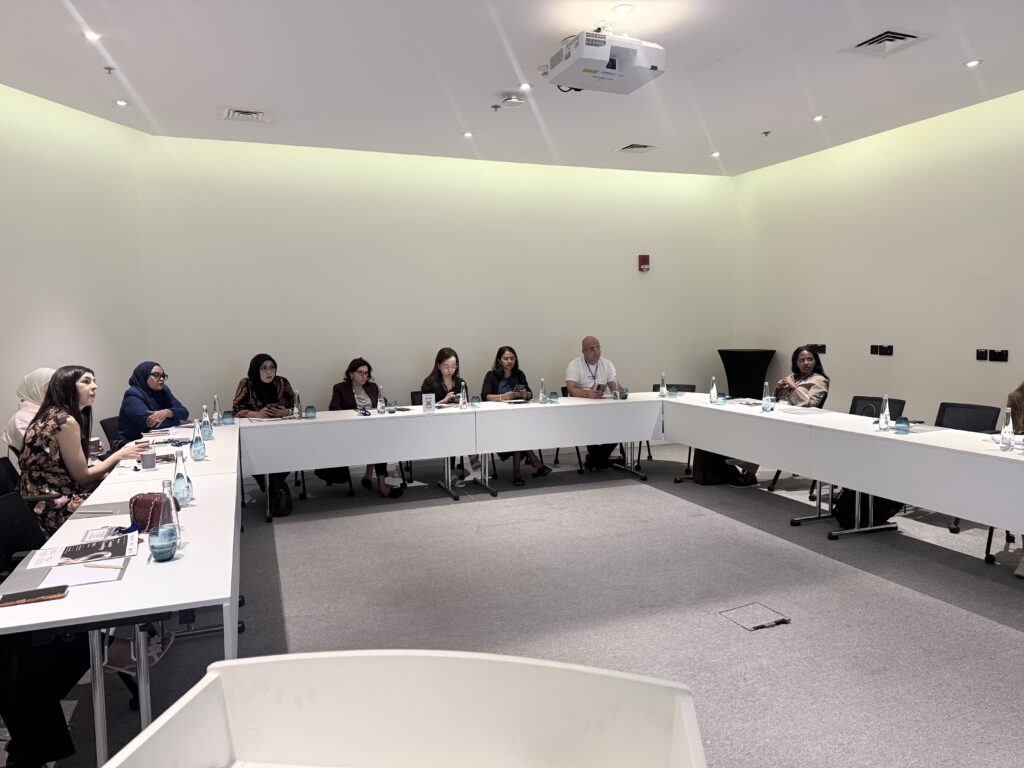 Participants seated around U-shaped tables during a classroom session.