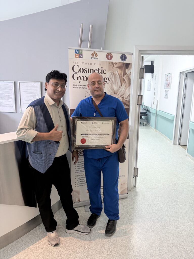 A man in blue scrubs displays his course certificate beside another man.
