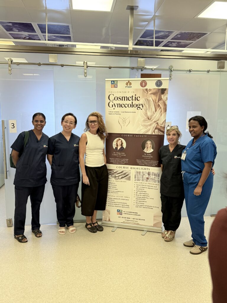 Five women pose beside the course banner, several in clinical scrubs.
