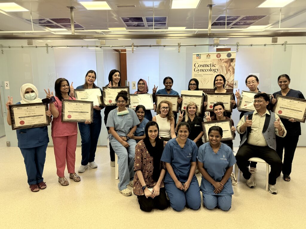The course group poses with certificates and celebratory hand gestures.